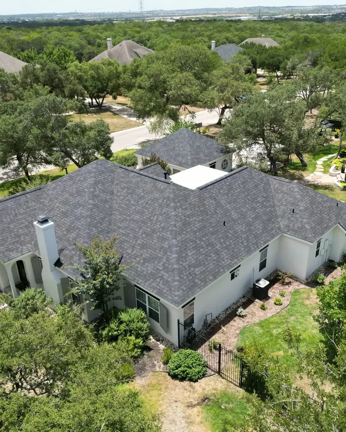 Two story home with a new charcoal shingle roof and clean ridge lines
