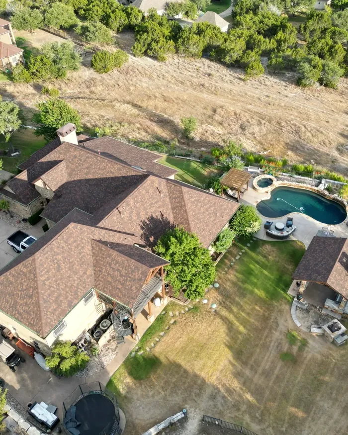 Single story home with a dark standing seam metal roof and white trim