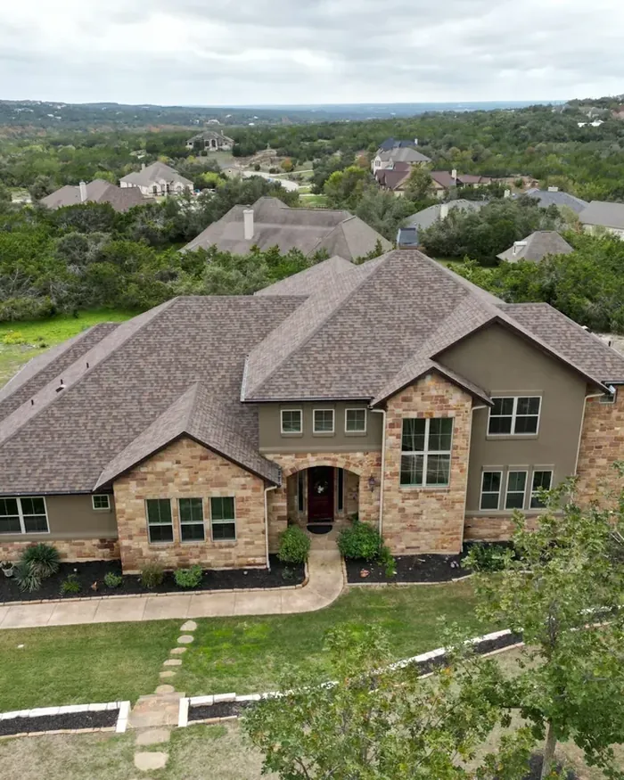 Long single story roof with new brown shingles and a clean valley
